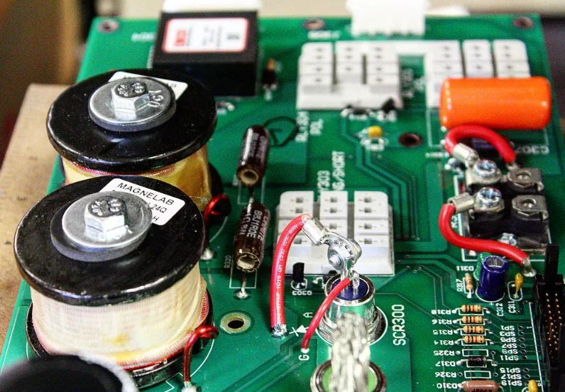 Close-up of the 858 circuit board with two wound inductors, capacitors, resistors and a thyristor