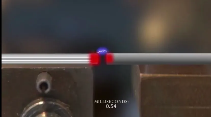 Slow-motion frame of two wire ends meeting with a blue-red flash, labeled 0.54 milliseconds