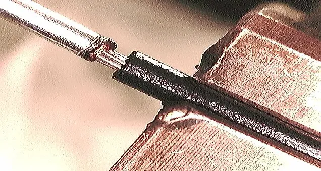 Magnified weld of a steel pin to stranded copper wire on a copper block