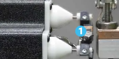 Electrode holders and clamp of the bench fixture with a numbered callout 1