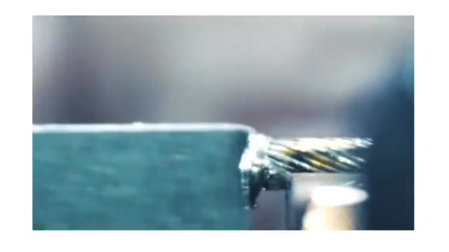 Extreme close-up of 14 AWG, 42-strand 27% nickel-clad copper wire being micro welded to 304 stainless steel.